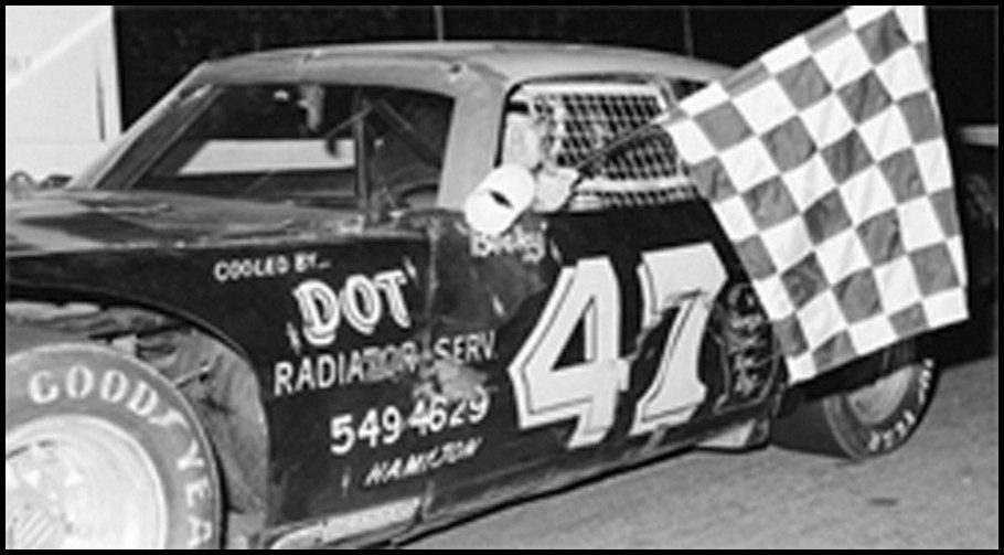 Ralph Book #takes the Checkers at Flamboro Speedway. Photo By Tex