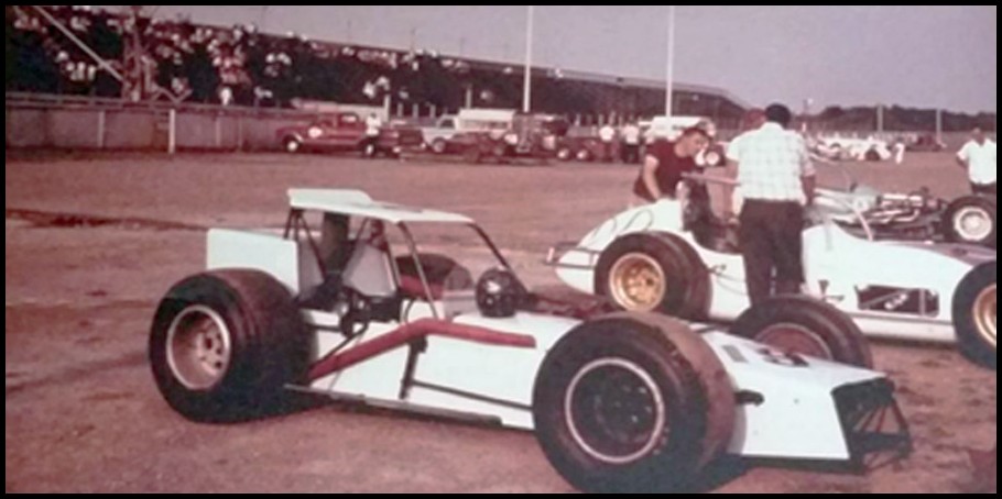 Gary Witters #19 Andy Browns #00 and Jimmy Shampines #8 Ball in the Pits at Oswego Speedway in 1967. Notice the grandstands were not yet covered at that time. Courtesy of Gary Anderson